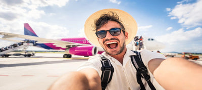 A man taking a selfie using a travel camera
